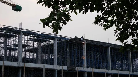 Slow motion fire sparkling, worker welding steel structure of construction site Stock Footage 90422446