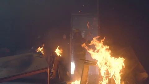 Slow motion firefighter/fire man kicked fired door open Stock Footage 109351633