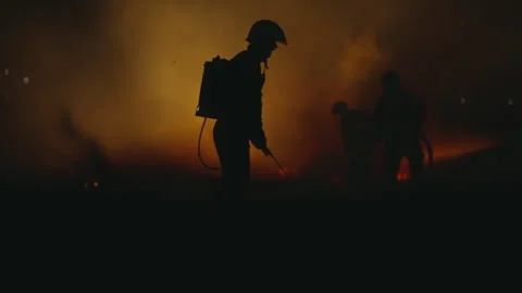 Slow motion Firefighters using Twirl water fog type fire extinguisher to figh Stock Footage 276659379