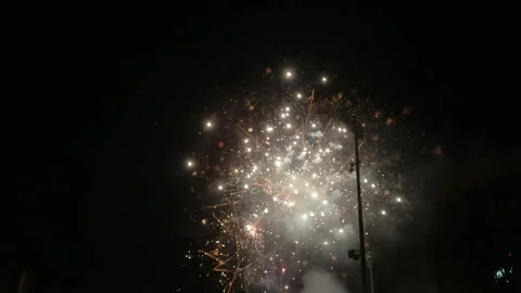 Slow motion fireworks exploding and sparkling over baseball stadium Stock Footage 300709679