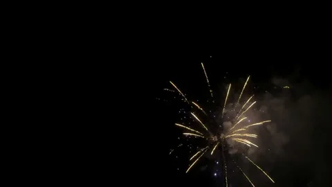 Slow motion fireworks exploding over pitch black sky Stock Footage 300709700