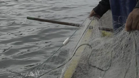 Slow Motion of Fisherman's Hands Pulling a Traditional Fishing Net at Dawn Stock Footage 320635127
