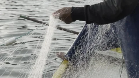 Slow Motion of Fisherman's Hands Pulling a Traditional Fishing Net at Dawn Stock Footage 320635149