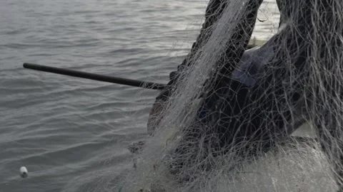 Slow Motion of Fisherman's Hands Pulling a Traditional Fishing Net at Dawn Stock Footage 320635158