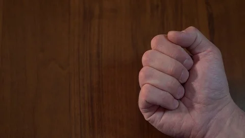 Slow motion. the fist opens and on the palm lies a green pill. on the background 動画素材 128840674