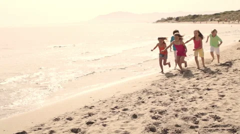Slow motion of five children running on beach Stock Footage 43672767