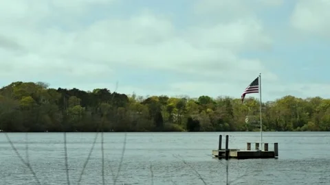 Slow Motion Flag Flying On Pole Over Lake Vídeos de archivo 148122993