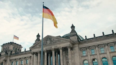 Slow Motion The flag of Germany against the background of the building of the Stock Footage 105032784