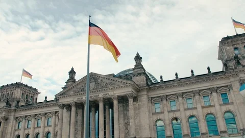 Slow Motion The flag of Germany against the background of the building of the Stock-Footage 106145568