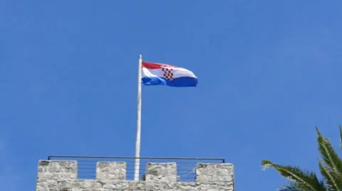 Slow Motion Flag on Stone Tower Stock Footage 54897557