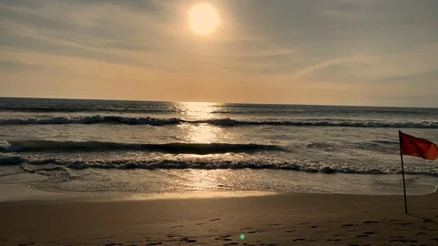 Slow motion of flag waving in the beach shore at sunset Stock Footage 125842818