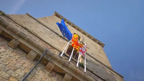Slow Motion Flags Hang From Castell de Montjüic in Barcelona, Catalonia, Spain Stock Footage 154837386