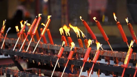 Slow-motion of flame from burning red chinese candle in temple Stock Footage 102452925