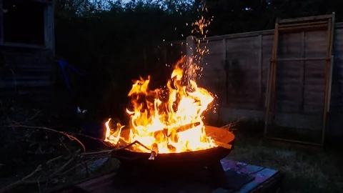 Slow motion flames leaping and crackling in a fire pit Stock Footage 128389007