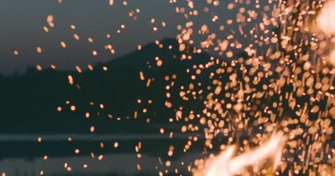 Slow Motion Flames Shooting Upwards with Sparks and a Mountain Background Stock Footage 144709149