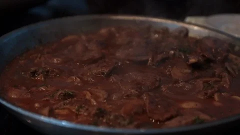 Slow motion flank steak bubbling in sauces close up Stock Footage 106112086