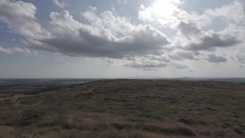 Slow motion flat color green rolling hills and valley landscape Stock Footage 340449353