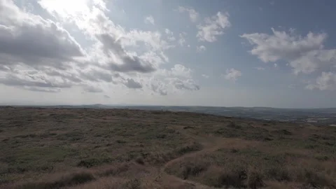 Slow motion flat profile landscape view over green countryside fields Stock Footage 340449318