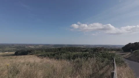 Slow motion flat profile panoramic view of valley under clouds Stock Footage 340449010