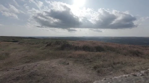 Slow motion flat profile panoramic hill summit view with clouds Stock Footage 340449523