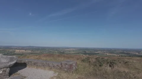 Slow motion flat profile stone viewpoint bench overlooking valley Stock Footage 340449427