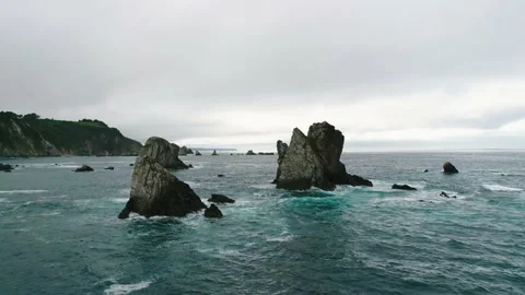 Slow motion flight over the waves crashing against the rocks. Stock Footage 150069709