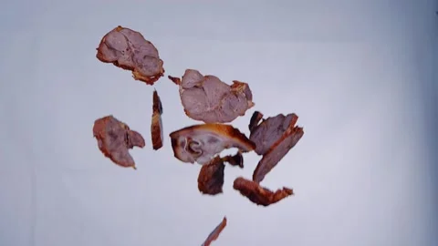 Slow motion flip meat slices up in the air flys down Stock Footage 169071604