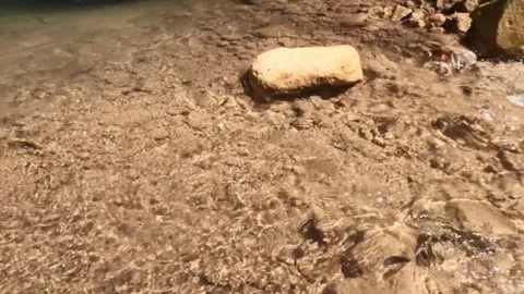 Slow motion of the flow of clear and shallow mountain river water Stock Footage 321325766