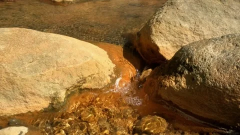 Slow motion flow of hot water in a rocky river Stock Footage 307432254