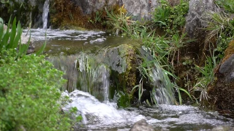 Slow motion Flowing water stream, water drops and reflection Stock Footage 104979919