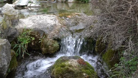 Slow motion Flowing water stream, water drops and reflection Stock Footage 104979928