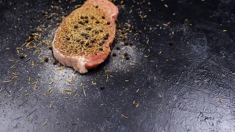 Slow motion fly over crane shot of richly seasoned piece of raw pork meat Stock Footage 83179385