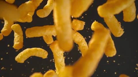 Slow motion of flying corn chips on a black background Stock Footage