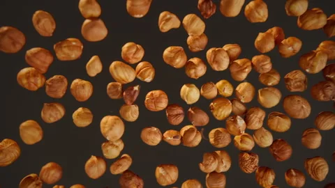 Slow motion of flying hazelnuton a black background Stock Footage 148162736