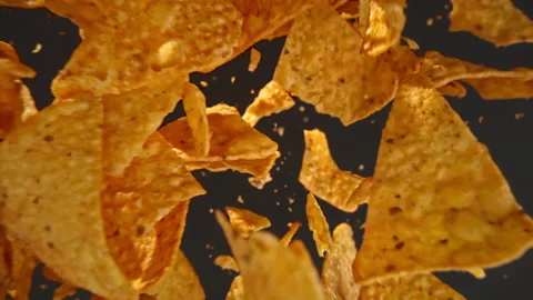 Slow motion of flying nachos chips on a black background Stock Footage 148159684