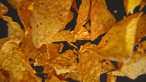 Slow motion of flying nachos chips on a black background Stock Footage 148159687