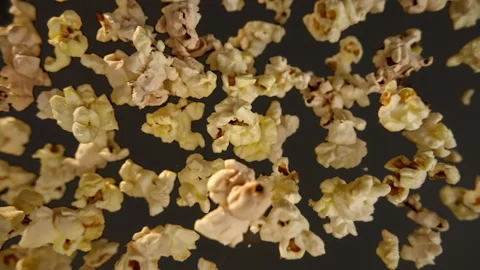 Slow motion of flying popcorn on a black background Vídeo Stock 148180672