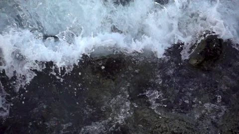 Slow motion foam wave with splashes crashing on the shore Stock Footage 108512085