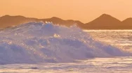 Slow Motion: Foaming Water Coming From Ocean Reaching Coast On Beautiful Evening Stock Footage