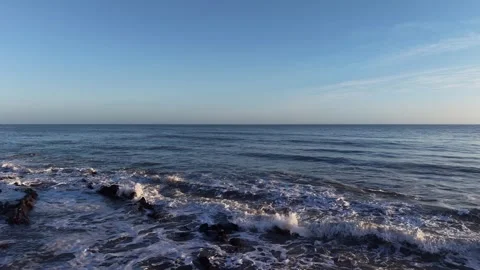 Slow Motion Foamy Ocean Surface Near Coastline in 4K Stock Footage 332944204