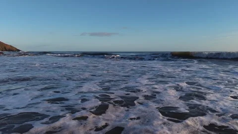 Slow Motion Foamy Ocean Surface Near Coastline in 4K Stock Footage 332944538