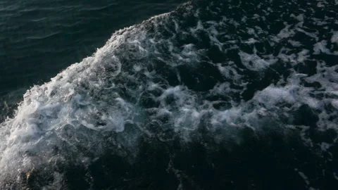 Slow motion of a foamy wave over the surface of the water Stock Footage 122562721