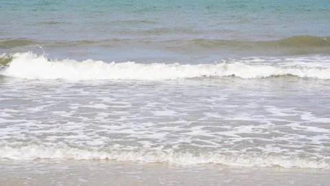 Slow motion of foamy waves rolling towards the sand beach 스톡 동영상 133863093