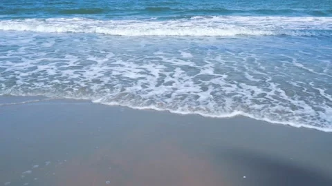 Slow motion of foamy waves rolling towards the sand beach Video stock 221392414