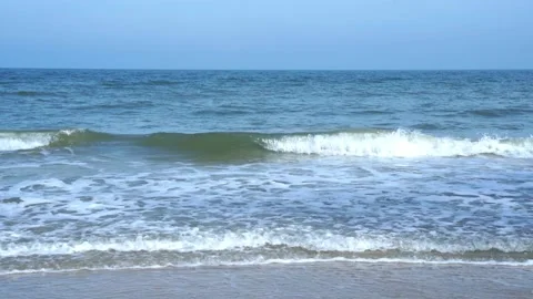 Slow motion of foamy waves rolling towards the sand beach Video stock 221397625