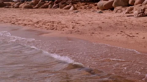 Slow motion of foamy waves rolling towards white sand beach under low sunlight Stock Footage 234417468