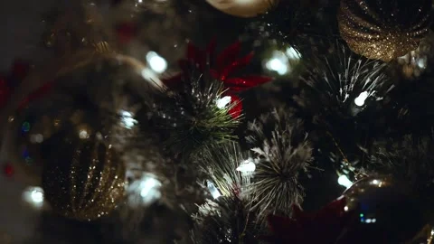 Slow-motion in focus Christmas lights and ornaments on a green evergreen tree Stock-Footage 295741126