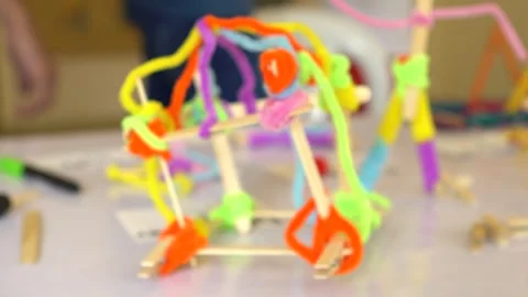Slow Motion Focusing On Several Pipe Cleaner And Popsicle Stick Catapult Stock-Footage 300728626