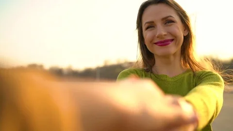 Slow motion follow me - happy young woman pulling guy's hand - hand in hand Stock Footage 74221853