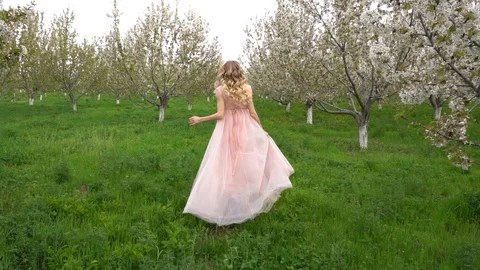 Slow motion following back five years age brunette girl with blue dress running Stock Footage 128434726